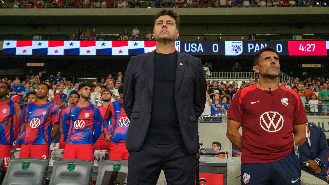 United States head coach Mauricio Pochettino, front left, and first assistant coach Jesus Perez, right, stand for the national anthem before an international friendly soccer match against Panama, Saturday, Oct. 12, 2024, in Austin, Texas. (AP Photo/Rodolfo Gonzalez)