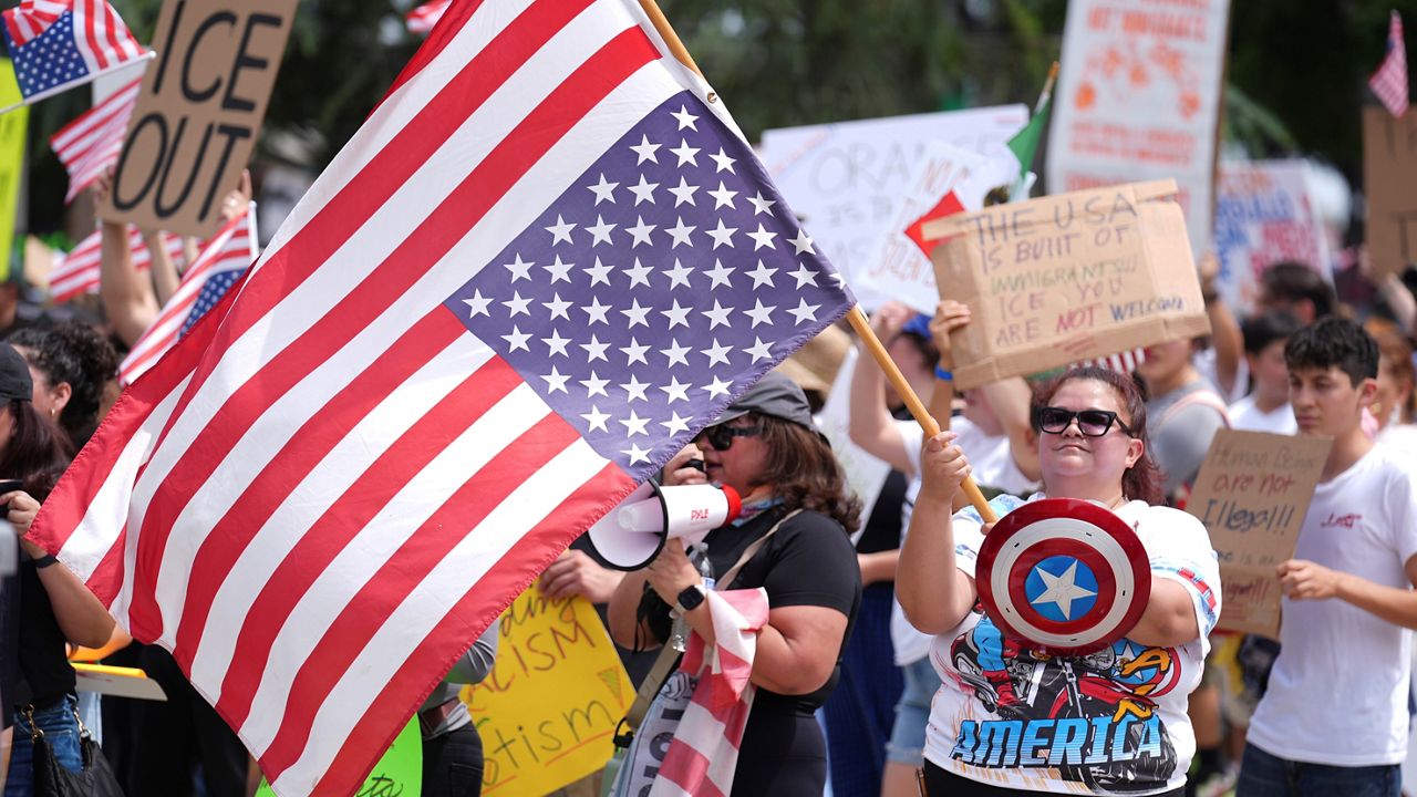 Denise Skidmore of Whittier, Calif., holds a U.S. flag during a 