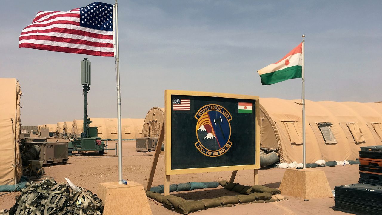 A U.S. and Niger flag are raised side by side at the base camp for air forces and other personnel supporting the construction of Niger Air Base 201 in Agadez, Niger, April 16, 2018. (AP Photo/Carley Petesch, File)