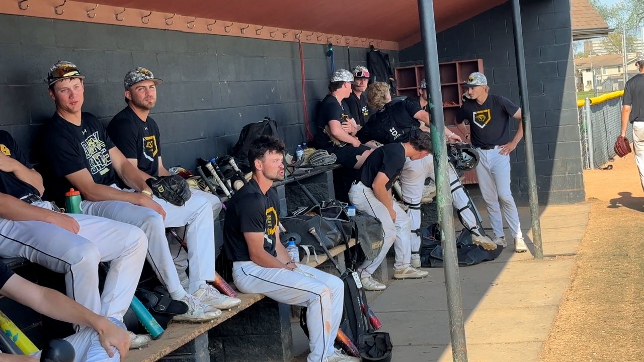 UWO baseball team sitting in the dugout 