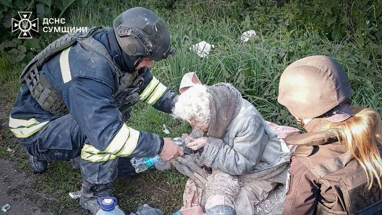 In this photo provided by the Ukrainian Emergency Services on May 8, 2025, a rescue worker helps an injured elderly woman evacuated from a building which was heavily damaged by a Russian strike in Sumy region, Ukraine. (Ukrainian Emergency Service via AP)