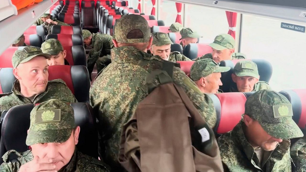 In this photo taken from a video released by Russian Defense Ministry press service, Russian servicemen ride a bus after returning from captivity after an exchange between Russia and Ukraine, at an undisclosed location in Belarus, Saturday, May 24, 2025. (Russian Defense Ministry Press Service via AP)
