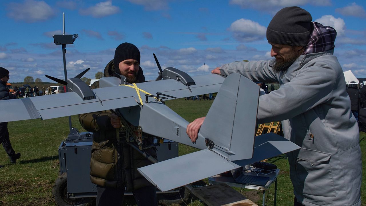 A manufacturer demonstrates a Ukrainian made drone at a Ukraine Defense Innovations exhibition for military clients on an undisclosed location in Ukraine, Friday, April 11, 2025. (AP Photo/Efrem Lukatsky, File)