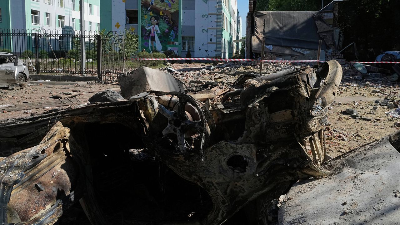 Damaged cars lie in a yard among other debris after a Russian drone and missile attacks in Kyiv, Ukraine, Friday, July 4, 2025. (AP Photo/Efrem Lukatsky)