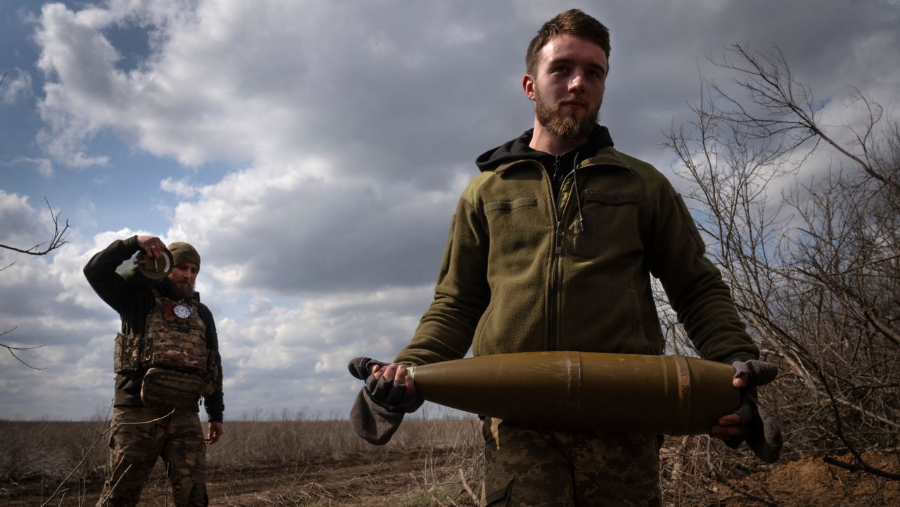 Ukrainian soldiers carry shells to fire at Russian positions on the front line, near the city of Bakhmut, in Ukraine's Donetsk region, on March 25, 2024. (AP Photo/Efrem Lukatsky, File)