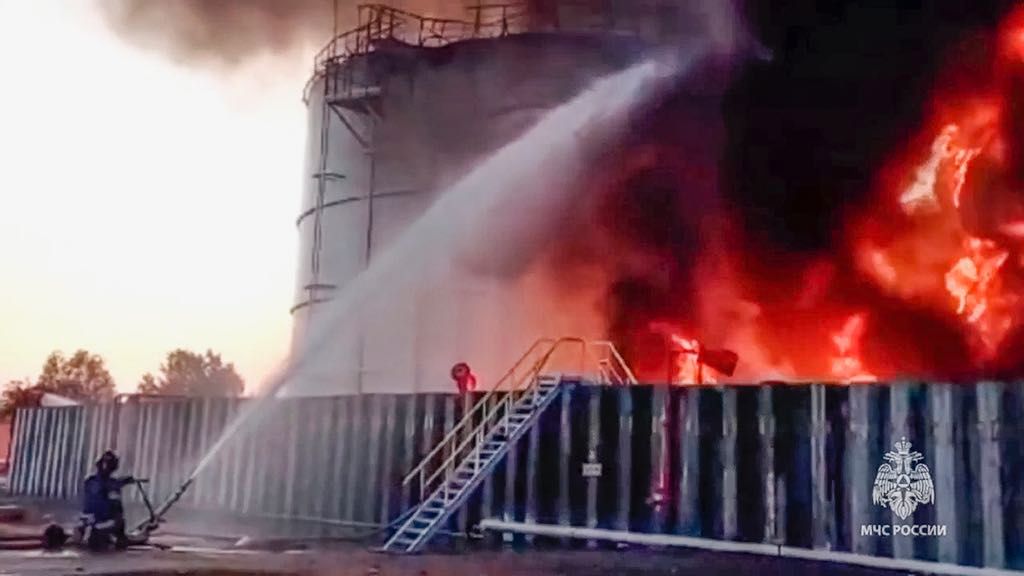 In this photo taken from video released by the Russian Emergency Ministry Press Service on Tuesday, June 18, 2024, firefighters work at the scene of an oil reservoir fire in Azov district of Rostov-on-Don region of Russia. Vasily Golubev, the governor of the Rostov region, said that a Ukrainian drone attack caused the fire at the oil reservoir. The Emergencies Ministry said over 70 firefighters are fighting the blaze that covers the area of 5,000 square meters. (Russian Emergency Ministry Press Service via AP)