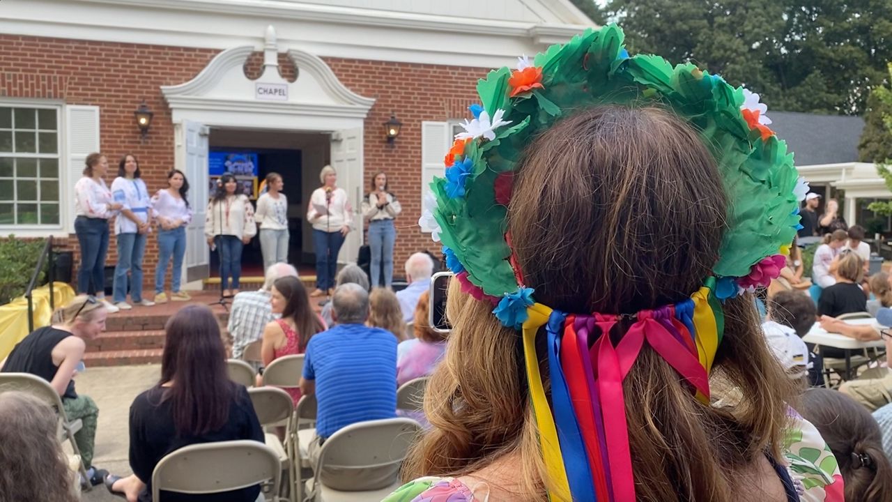 A woman watching Ukrainian singers at the cultural center. (Spectrum News 1/Kyleigh Panetta)