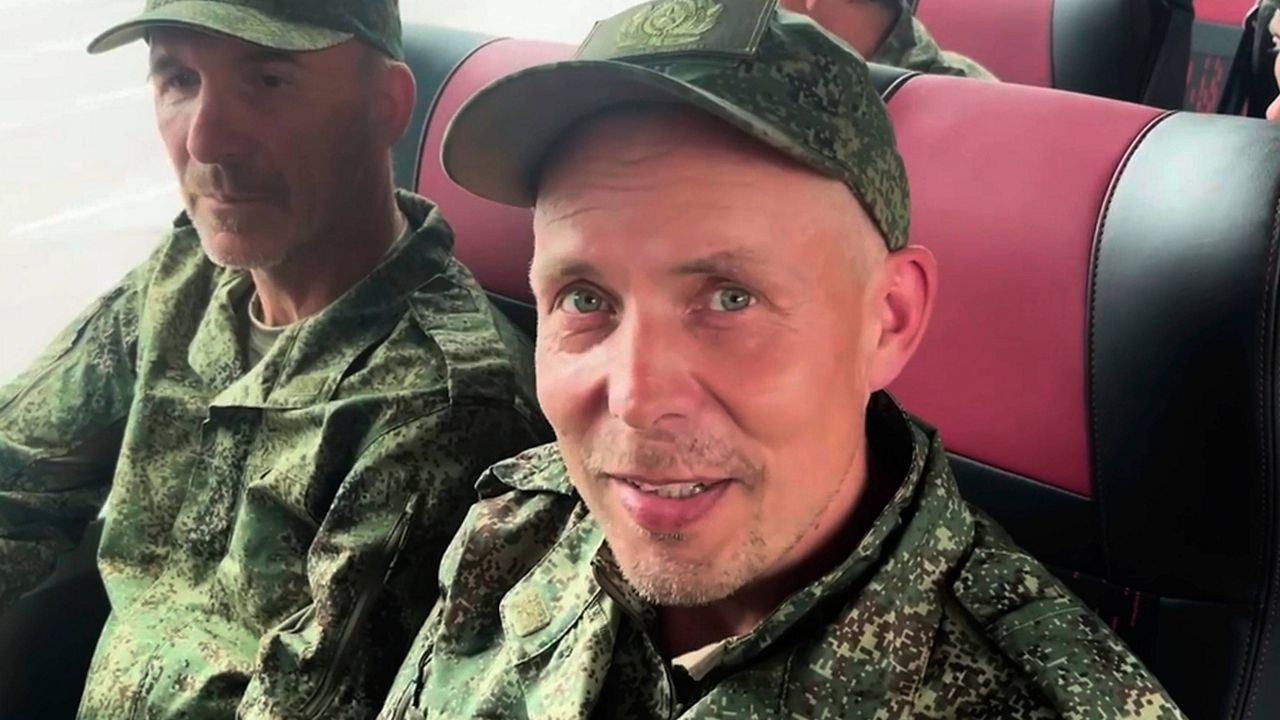In this photo, taken from a video released by Russian Defense Ministry press service, Russian servicemen sit in a bus after returning from captivity after an exchange between Russia and Ukraine, at an undisclosed location in Belarus, Saturday, May 24, 2025. (Russian Defense Ministry Press Service via AP)