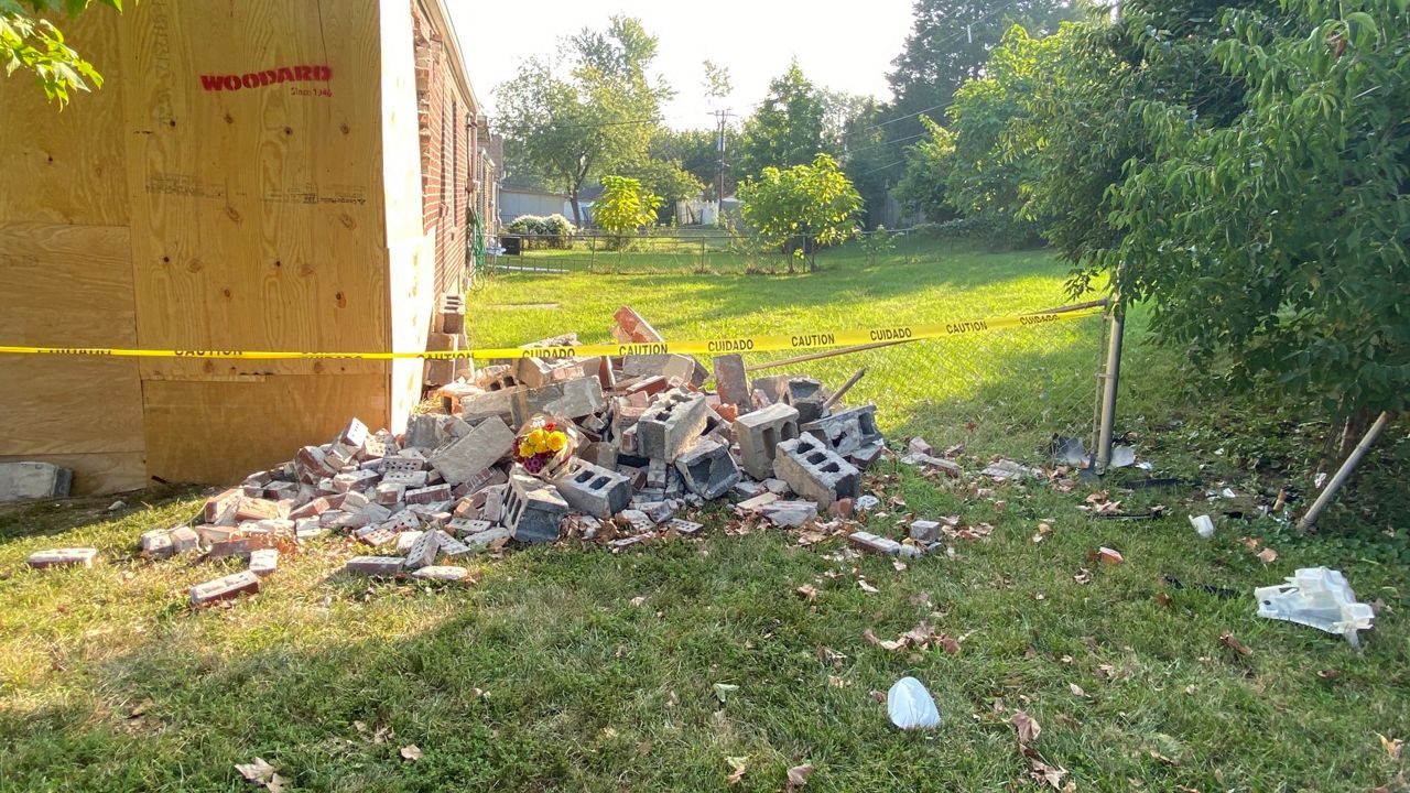 A University City home is boarded up after a car crashed into it, killing three 15-year-old boys. (Spectrum News/Becky Willeke)