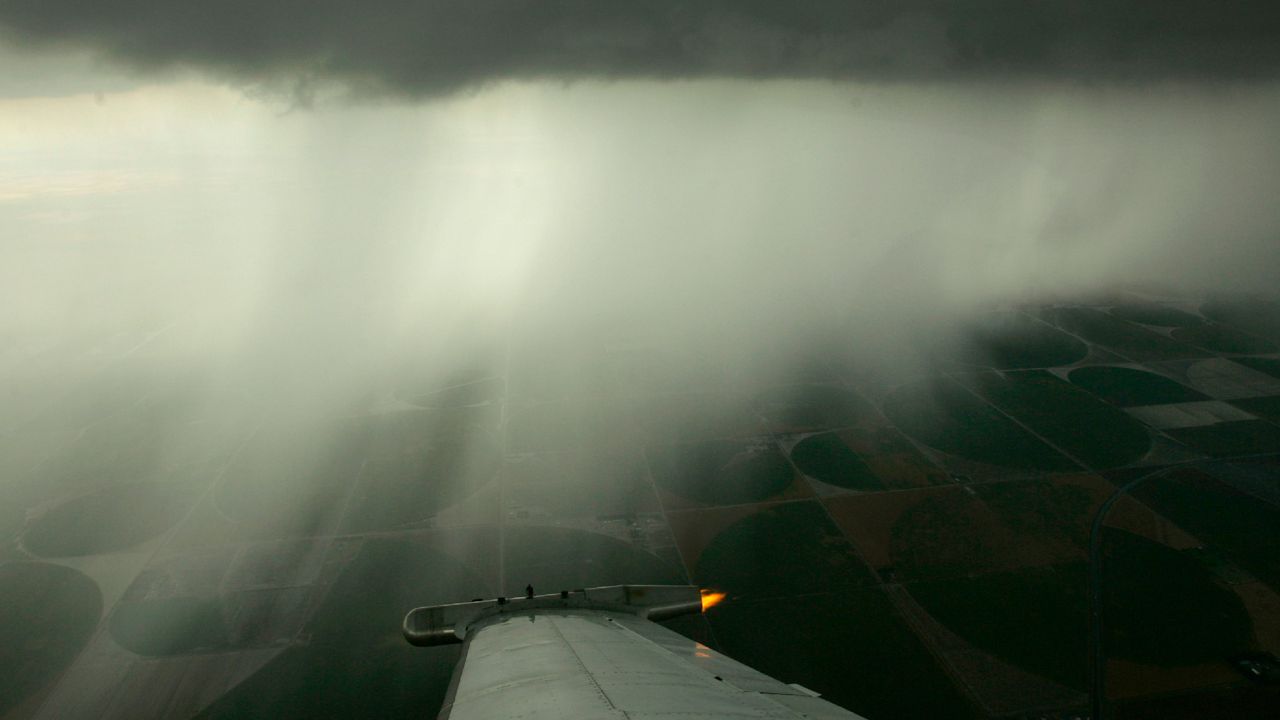 Plane flying over crops. (AP/Charlie Riedel)
