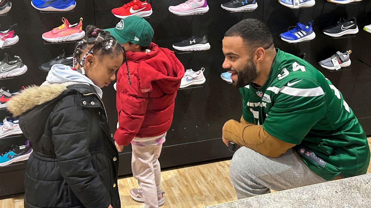 New York Jets defensive lineman Solomon Thomas chats with a student from Brooklyn Community Services Jets' Academy during a holiday shopping spree hosted by the team at Dick's Sporting Goods in East Hanover, N.J., on Tuesday, Dec. 12, 2023. (AP Photo/Dennis Waszak Jr.)