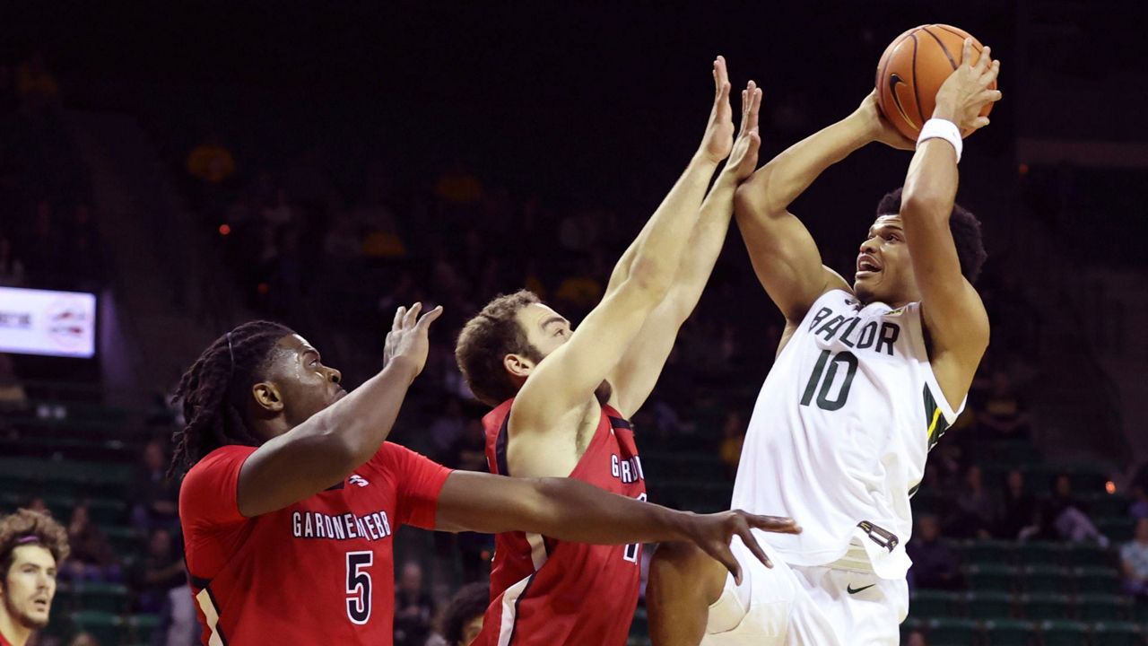 Baylor guard RayJ Dennis (10) attempts to shoot over Gardner-Webb guard Shahar Lazar, center, and forward Ademide Badmus (5) in the first half of an NCAA college basketball game, Sunday, Nov. 12, 2023, in Waco, Texas. (AP Photo/Jerry Larson)