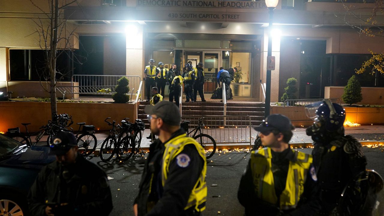 U.S. Capitol Police stand outside the headquarters of the Democratic National Committee Wednesday, Nov. 15, 2023, in Washington. (AP Photo/Nathan Howard)