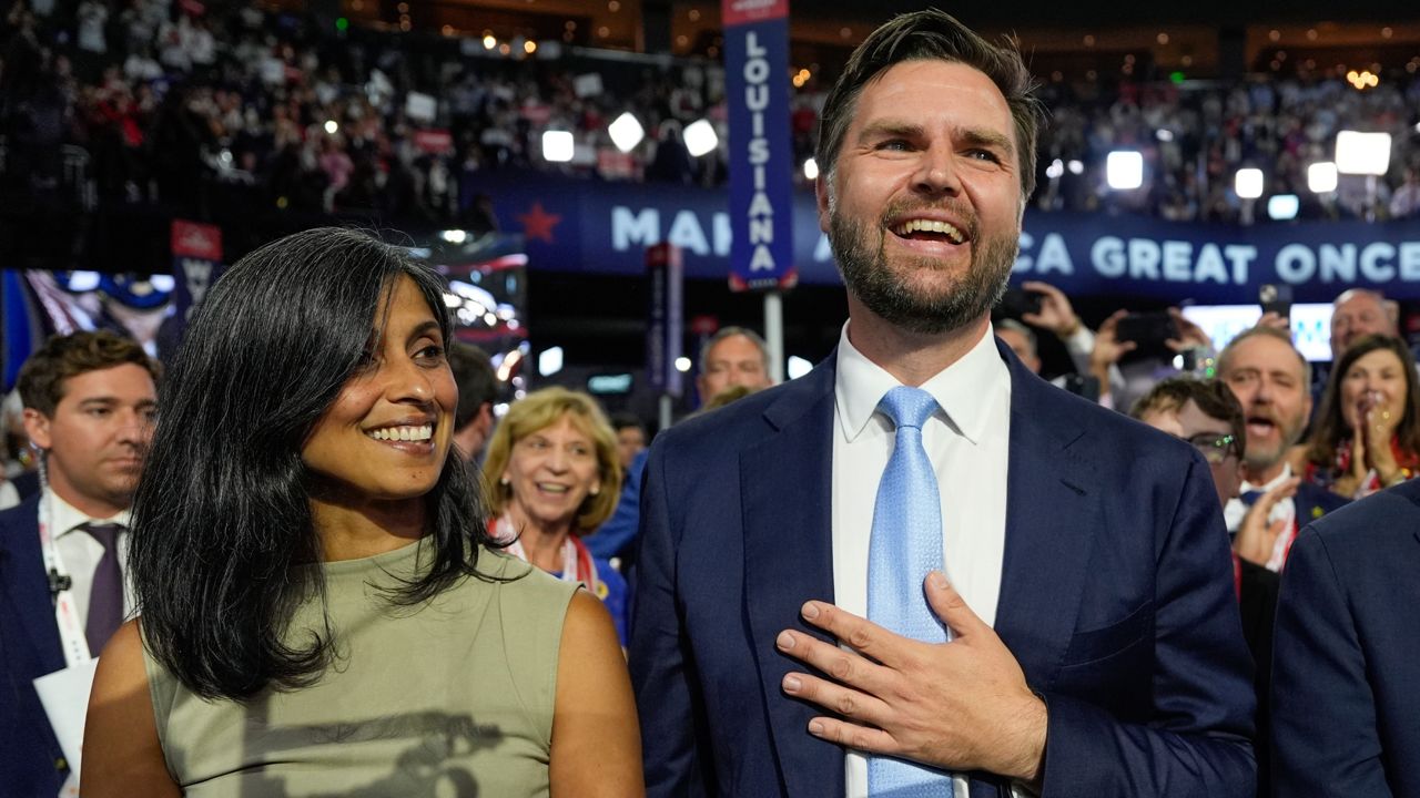 Republican vice presidential candidate Sen. JD Vance, R-Ohio, and his wife Usha Chilukuri Vance arrive on the floor during the first day of the 2024 Republican National Convention at the Fiserv Forum, Monday, July 15, 2024, in Milwaukee.