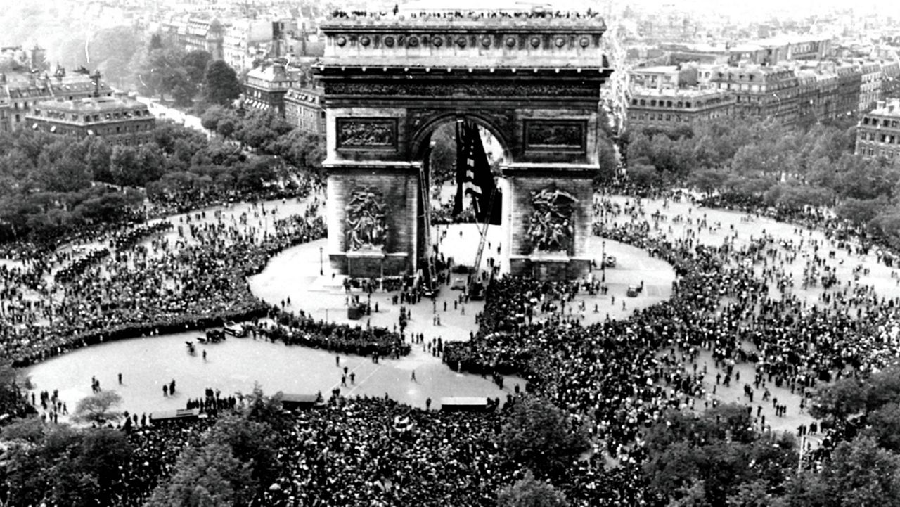 Thousands celebrate the announcement of Germany's unconditional surrender to the Allies in World War II, on May 7, 1945, at the Arc de Triomphe in Paris on VE Day. (AP Photo/File)