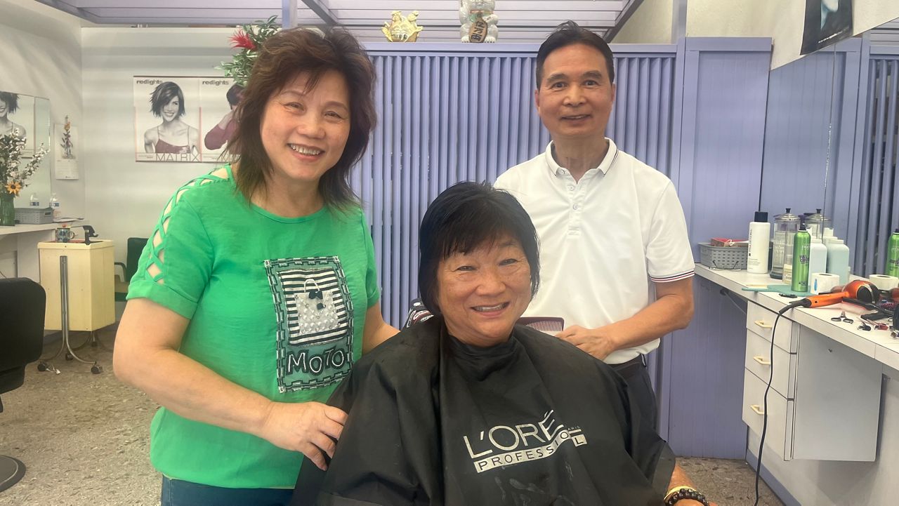 Longtime customer Lois Sismar, here with Varsity Barber owners Stella and June Chan, says she doesn't know where she'll to to have her hair done now that her favorite barber shop has closed. (Spectrum News/Michael Tsai)