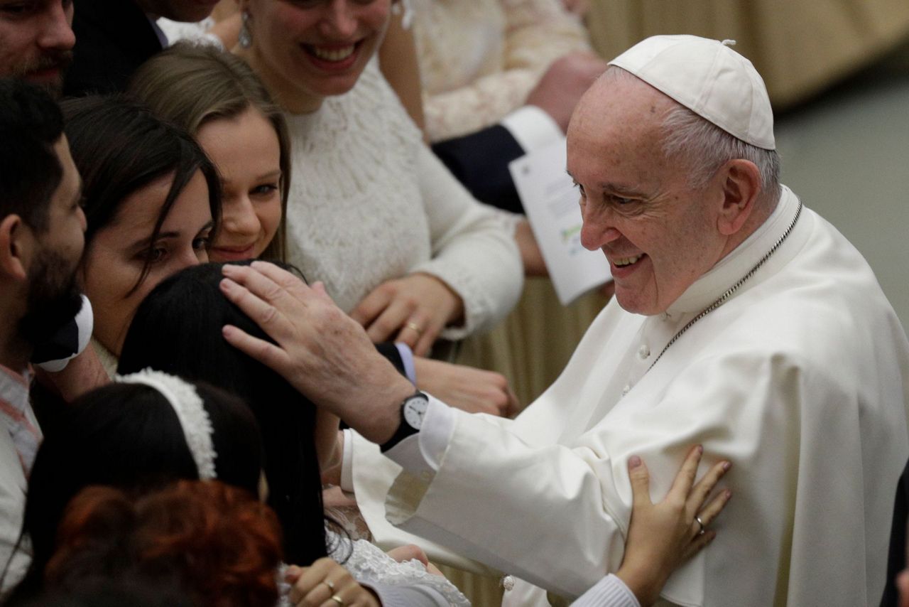 "Don't bite!" Pope negotiates papal kiss after controversy