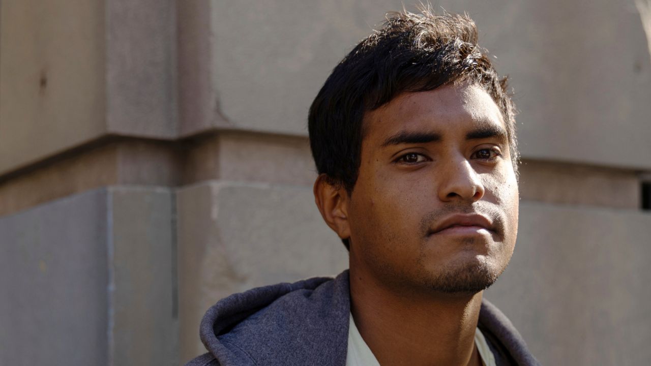 Cleiver Rodriguez, 24, poses for a portrait, Thursday, Sept. 15, 2022, in New York. Rodriguez, an immigrant from Venezuela, arrived to Manhattan in a bus sent by Texas governor Greg Abbott and is thankful for a free ride to New York. (AP Photo/Julia Nikhinson)