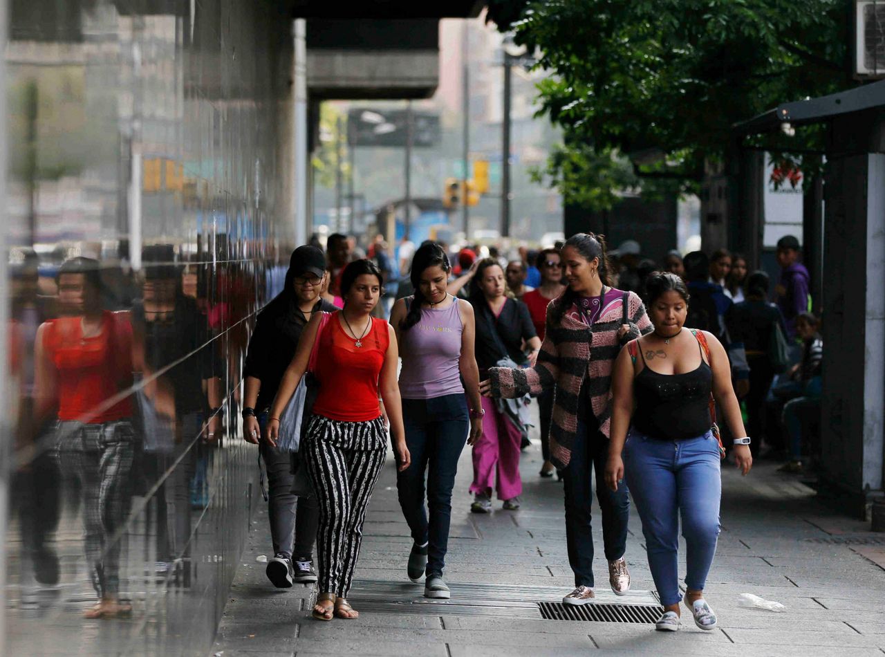 Pedestrians walk to their destination amid the country’s worst-ever power o...