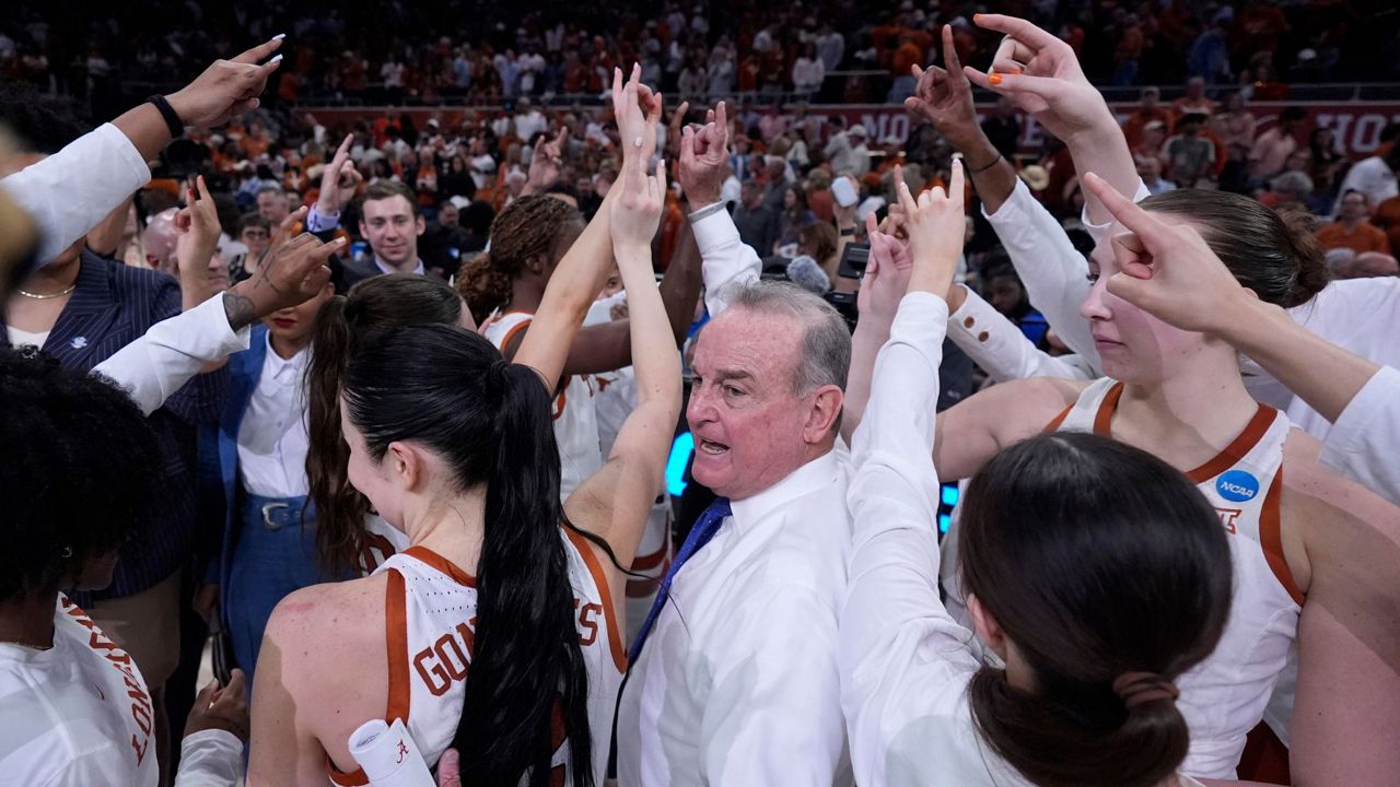 Texas head coach Vic Schaefer, center, celebrates with his team after their win over Alabama in a second-round college basketball game in the women's NCAA Tournament in Austin, Texas, Sunday, March 24, 2024. (AP Photo/Eric Gay)