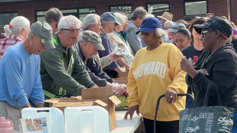 Hundreds gather at People's Place on Tuesday for weekly Farm Stand. Photo By: Darcie Ortique