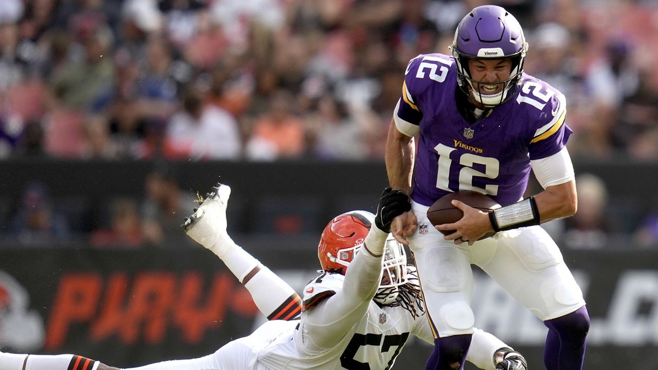 Cleveland Browns defensive end Isaiah McGuire (57) reaches for Minnesota Vikings quarterback Nick Mullens (12) during the first half of an NFL preseason football game, Saturday, Aug. 17, 2024, in Cleveland. (AP Photo/Sue Ogrocki)