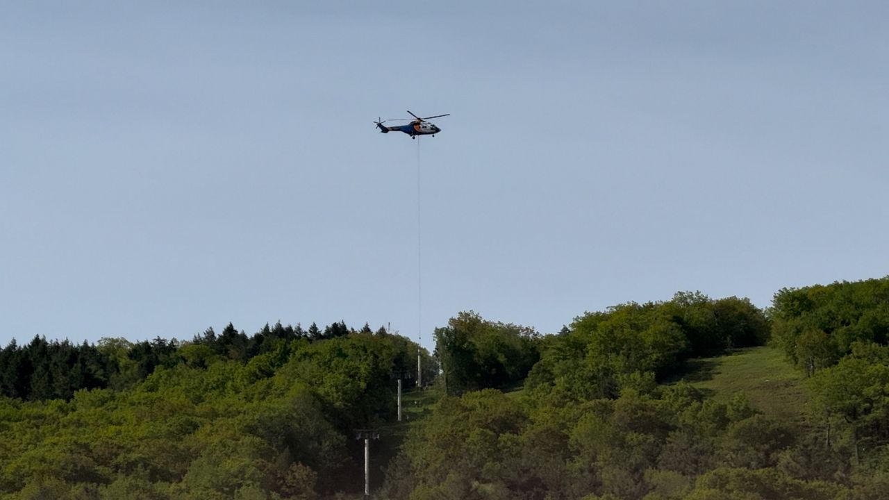 A helicopter removes a piece of the Polar Express chairlift at Wachusett Mountain on Wednesday. (Spectrum News 1/Devin Bates)