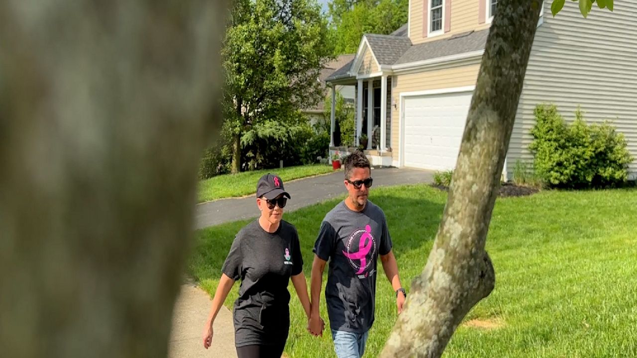 David Szydlowski and Erin Walsh are walking around their neighborhood to prepare for the Susan G. Komen Race for the Cure. (Spectrum News 1/Aliah Keller)
