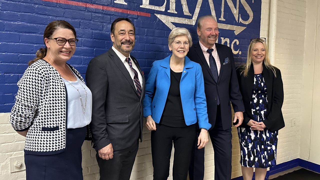 Sen. Elizabeth Warren (center) poses for a photo with Veterans Inc. leadership. (Spectrum News 1/Cam Jandrow)