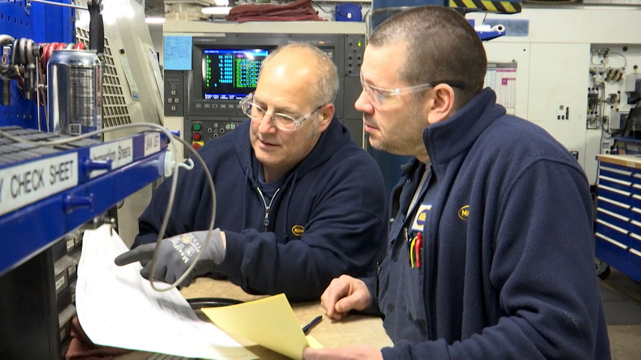 Andy Rorabeck chats with a fellow employee at Miba's facility in Grafton. 