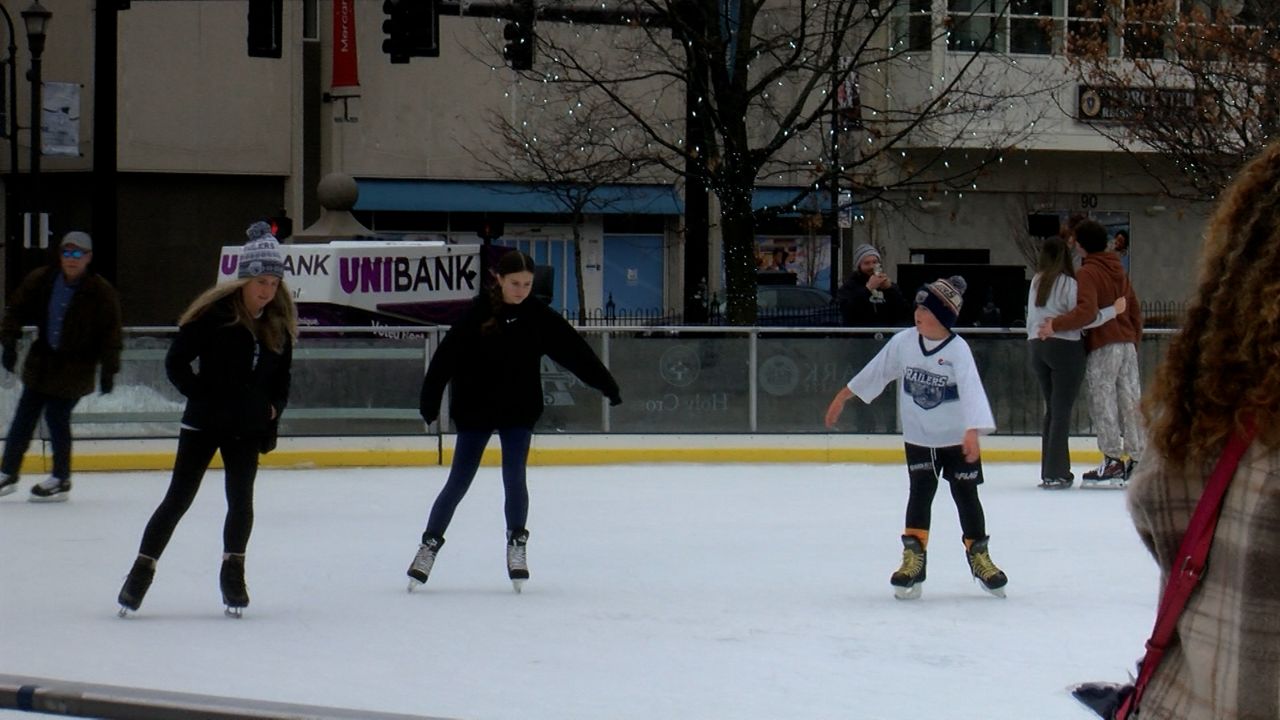 A group of people ice skate at the rink on the Worcester Common Oval on Sunday. (Spectrum News 1/Devin Bates)