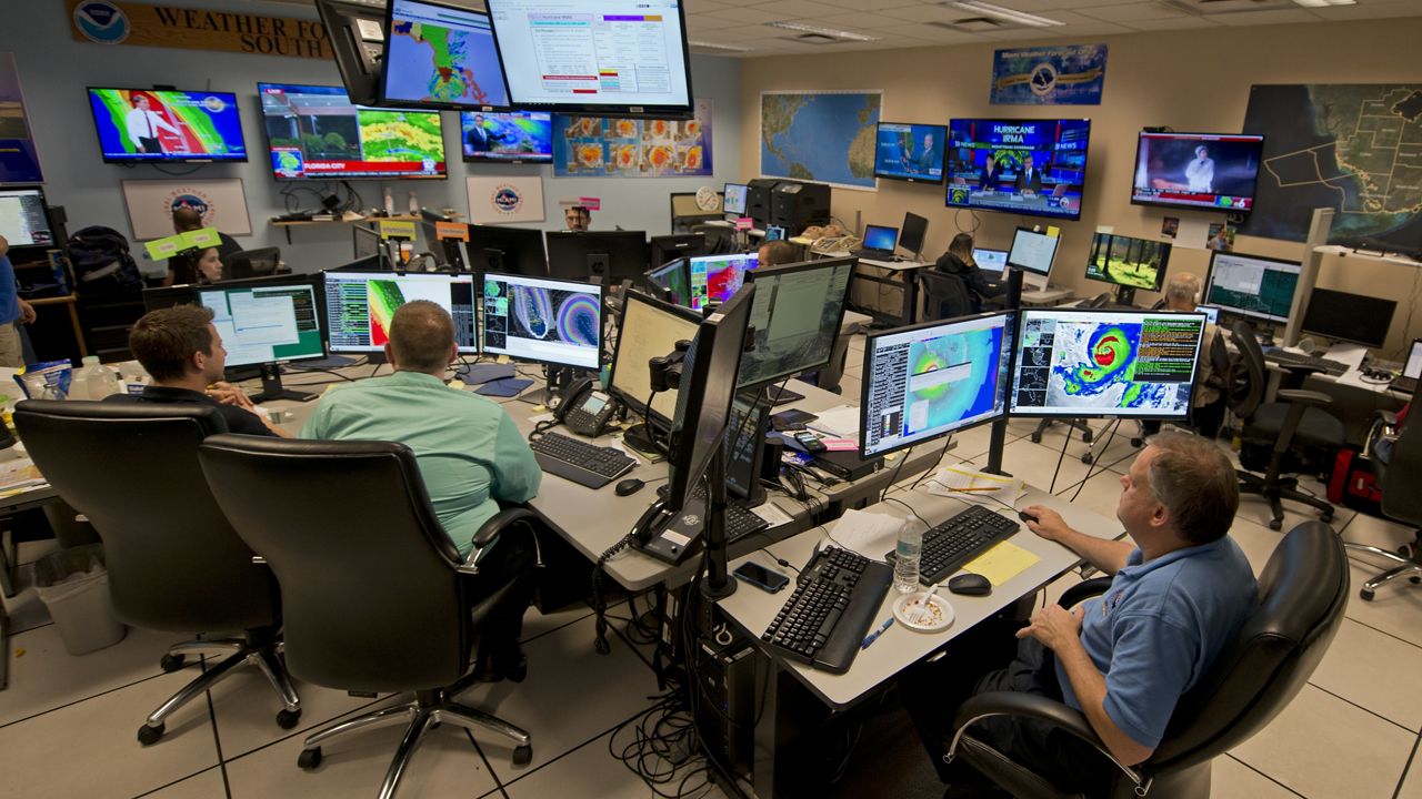 Forecasters at the National Weather Service office monitor Hurricane Irma Saturday, Sept. 9, 2017, at the hurricane center in Miami.