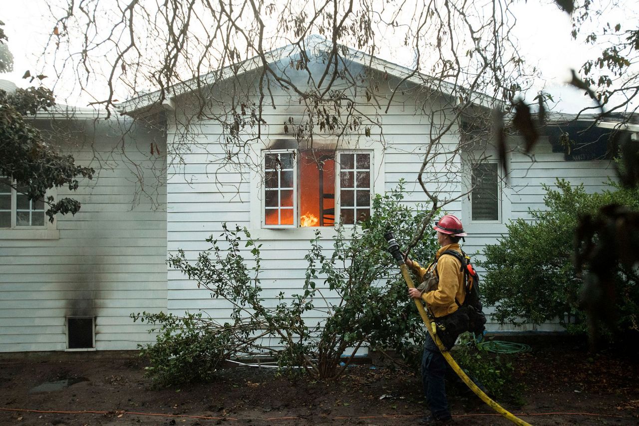 New wildfires sweep through California, burning homes