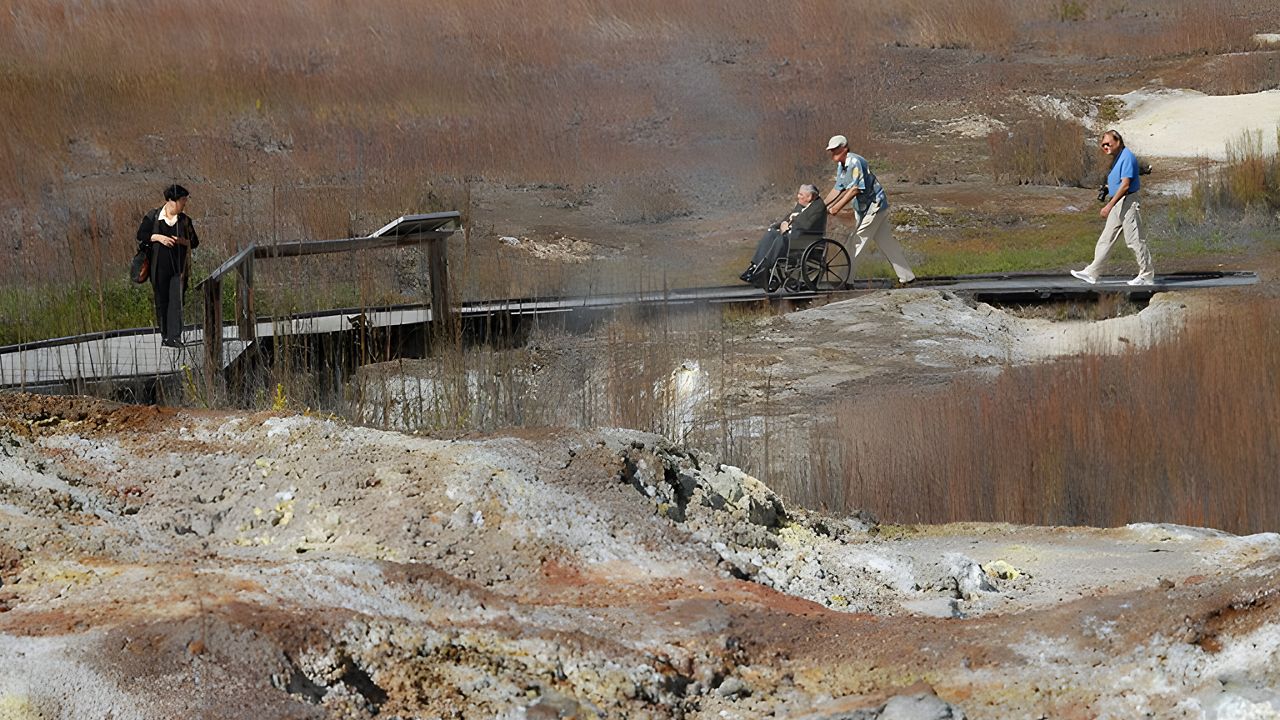 A person in a wheelchair is seen on the Sulphur Banks Trail at Hawaii Volcanoes National Park. (Photo courtesy of National Park Service)