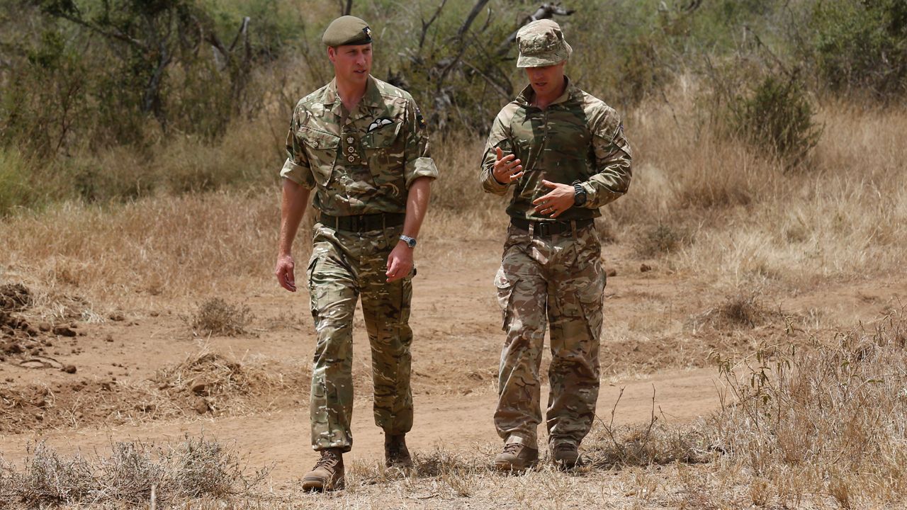 Then-Prince William, left, speaks with Major Ben Irwin-Clark, Company Commander, Number Two Company, right, during a visit to the 1st Battalion the Irish Guards battle group, training under the British Army Training Unit Kenya (BATUK), in Laikipia, Kenya Sunday, Sept. 30, 2018. (Thomas Mukoya/Pool via AP)