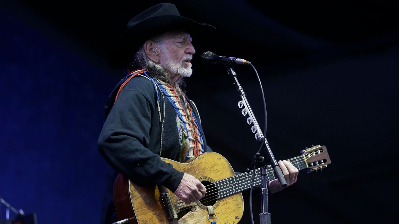 Willie Nelson performs at the New Orleans Jazz and Heritage Festival in New Orleans, Friday, May 3, 2013. (AP Photo/Gerald Herbert)