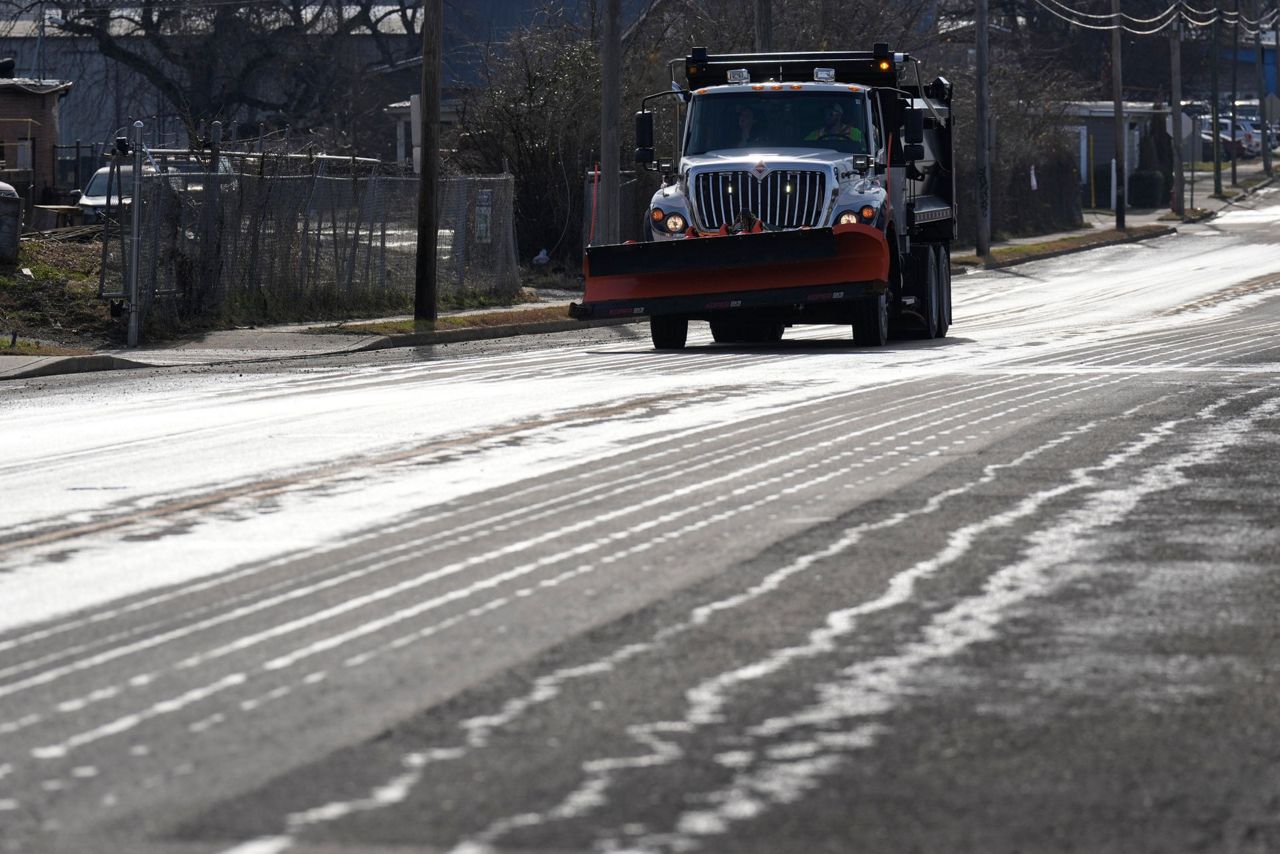 Crews spread salt on roads and people stock up on batteries as a winter ...