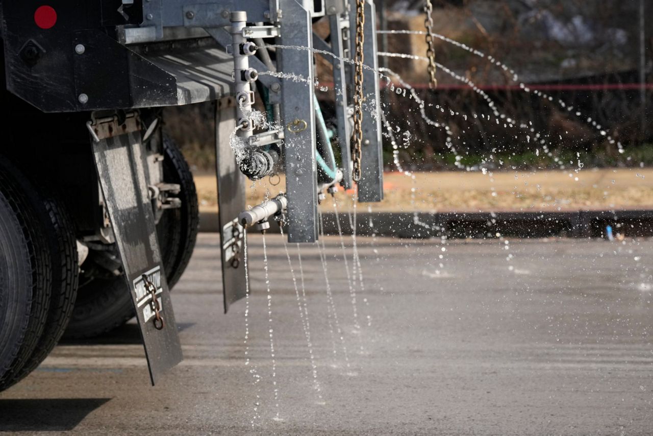 Crews spread salt on roads and people stock up on batteries as a winter ...