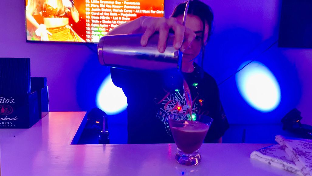 A bartender pours an espresso martini into a glass at The Lodge, a new experience at Winterfest this year. The event opens Saturday at Kiener Plaza. (Spectrum News/Elizabeth Barmeier) 