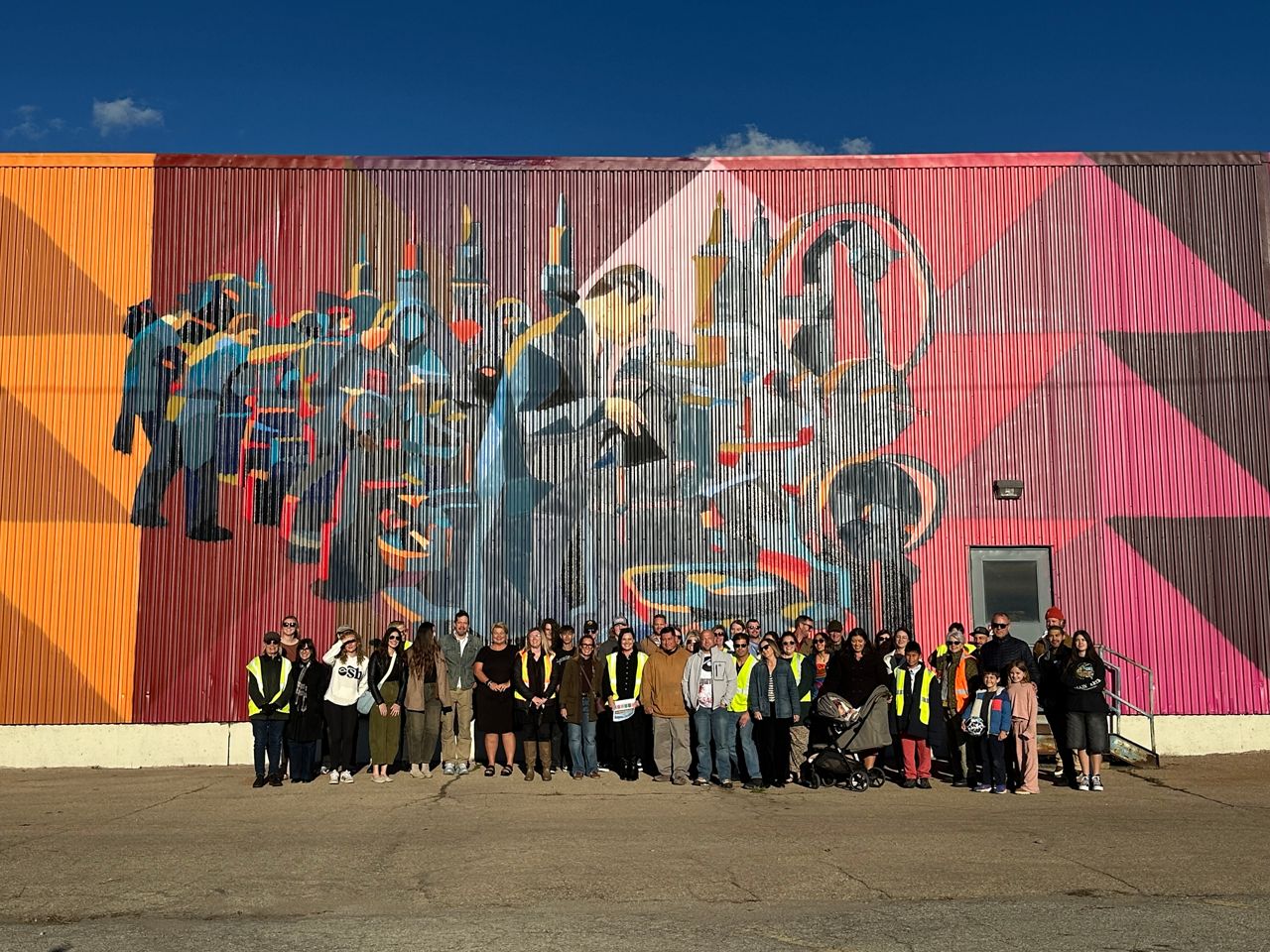 Photo of everyone who worked on Wisconsin's largest mural with their families in Oshkosh.