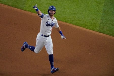 Los Angeles Dodgers' Mookie Betts scores on a fielders choice by Max Muncy  during the fifth inning in Game 1 of the baseball World Series against the  Tampa Bay Rays Tuesday, Oct.