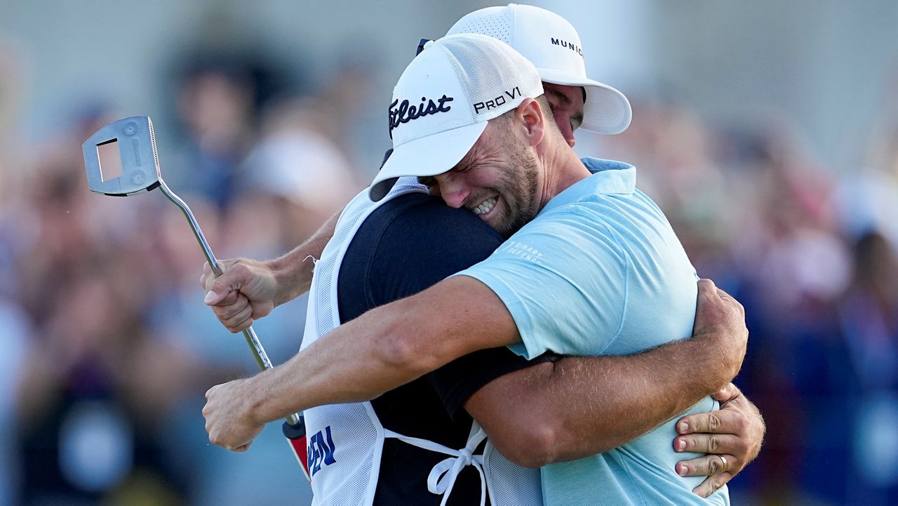 Wyndham Clark celebrates with his caddie after winning after the U.S. Open golf tournament at Los Angeles Country Club on Sunday, June 18, 2023, in Los Angeles. (AP Photo/George Walker IV)