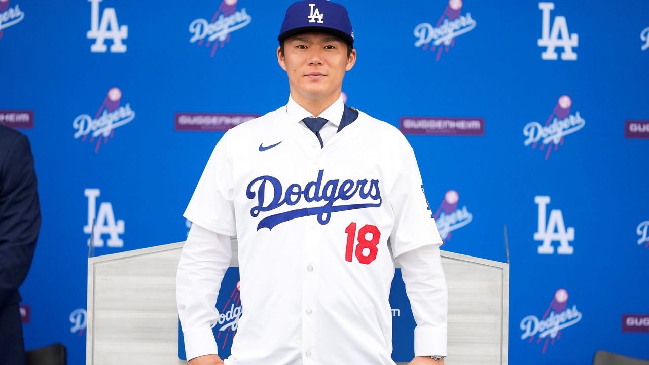 Yoshinobu Yamamoto wears his jersey during his introduction as a new member of the Los Angeles Dodgers baseball team Wednesday, Dec. 27, 2023, in Los Angeles. (AP Photo/Ashley Landis)