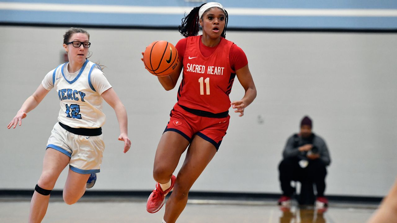 Sacred Heart Academy guard ZaKiyah Johnson dribbles during a high school basketball game against Mercy Academy in Louisville, Ky., Sunday, Feb. 11, 2024.