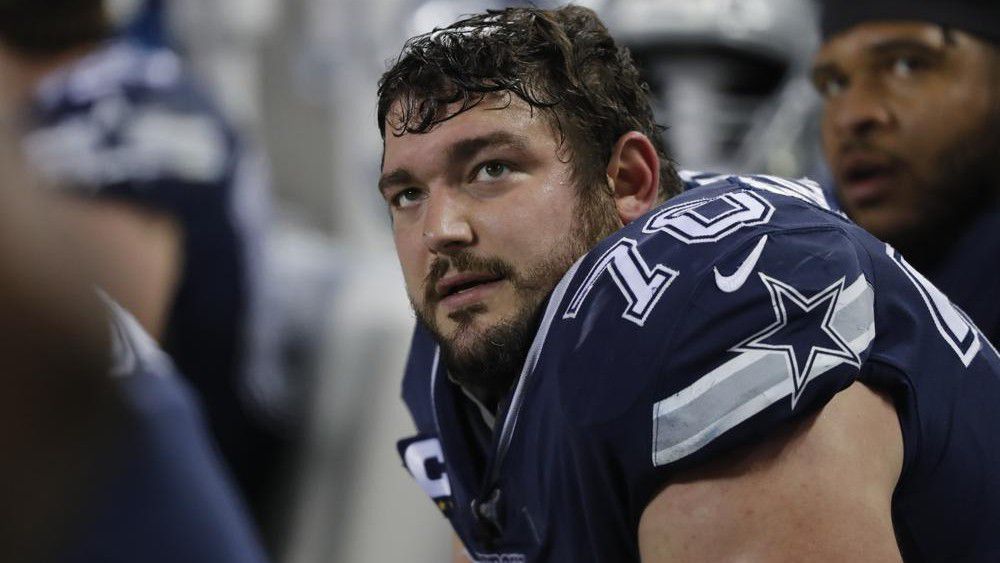 In this Dec. 5, 2019, file photo, Dallas Cowboys' Zack Martin watches from the bench during the second half of an NFL football game against the Chicago Bears in Chicago. The Cowboys are expected to open the season at Super Bowl champion Tampa Bay without right guard Martin after the four-time All-Pro tested positive for COVID-19. (AP Photo/Charles Rex Arbogast, File)