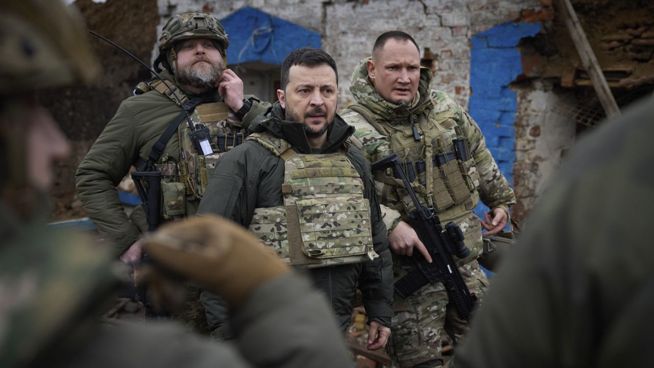 Ukrainian President Volodymyr Zelenskyy, cener, appears during his visit to Zaporizhzhia region, the site of fierce battles with the Russian troops in Ukraine, Sunday, Feb. 4, 2024. (Ukrainian Presidential Press Office via AP)