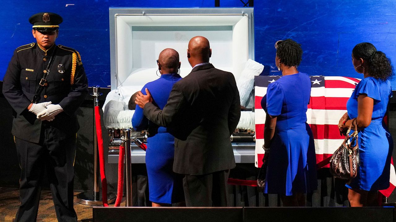 Mourners file past the casket of Dallas police officer Darron Burks before funeral services at Watermark Community Church on Saturday, Sept. 7, 2024, in Dallas. (Smiley N. Pool/The Dallas Morning News via AP, Pool)