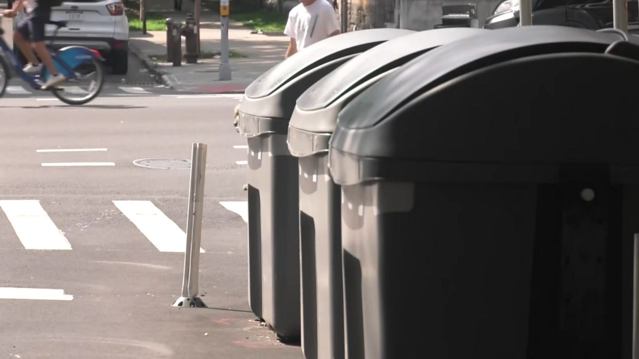 Harlem residents, drivers divided over on-street trash containers