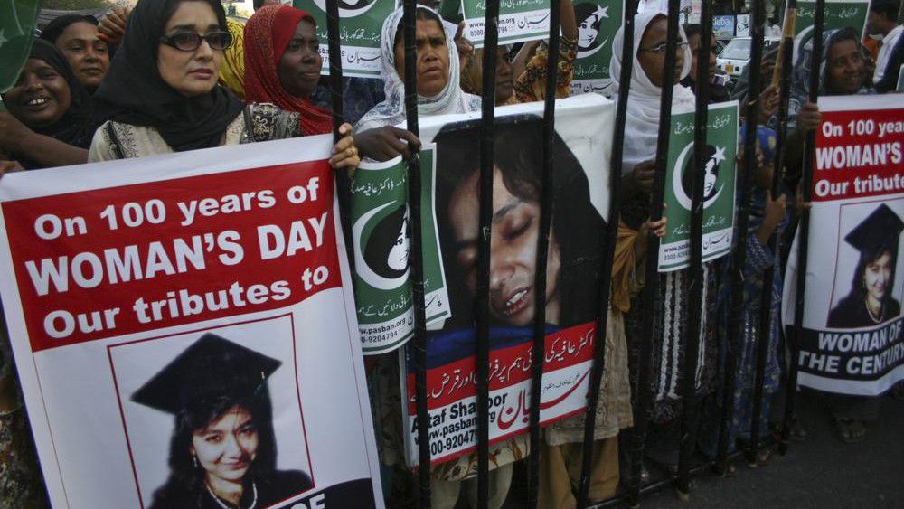 FILE - People rally demanding the release of Aafia Siddiqui, who was convicted in February 2010 of two counts of attempted murder, and who is currently being detained in the U.S. during International Women's Day in Karachi, Pakistan, Tuesday, March 8, 2011. The man who authorities say was holding hostages inside a Texas synagogue on Saturday, Jan. 15, 2022, demanded the release of Aafia Siddiqui, a Pakistani woman who is imprisoned on charges of trying to kill American service members in Afghanistan. (AP Photo/Fareed Khan, File)