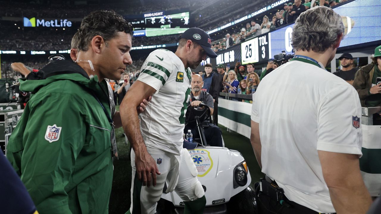New York Jets quarterback Aaron Rodgers (8) is helped off the field after getting injured during the first quarter of an NFL football game against the Buffalo Bills, Monday, Sept. 11, 2023, in East Rutherford, N.J.  (AP Photo/Adam Hunger, File)